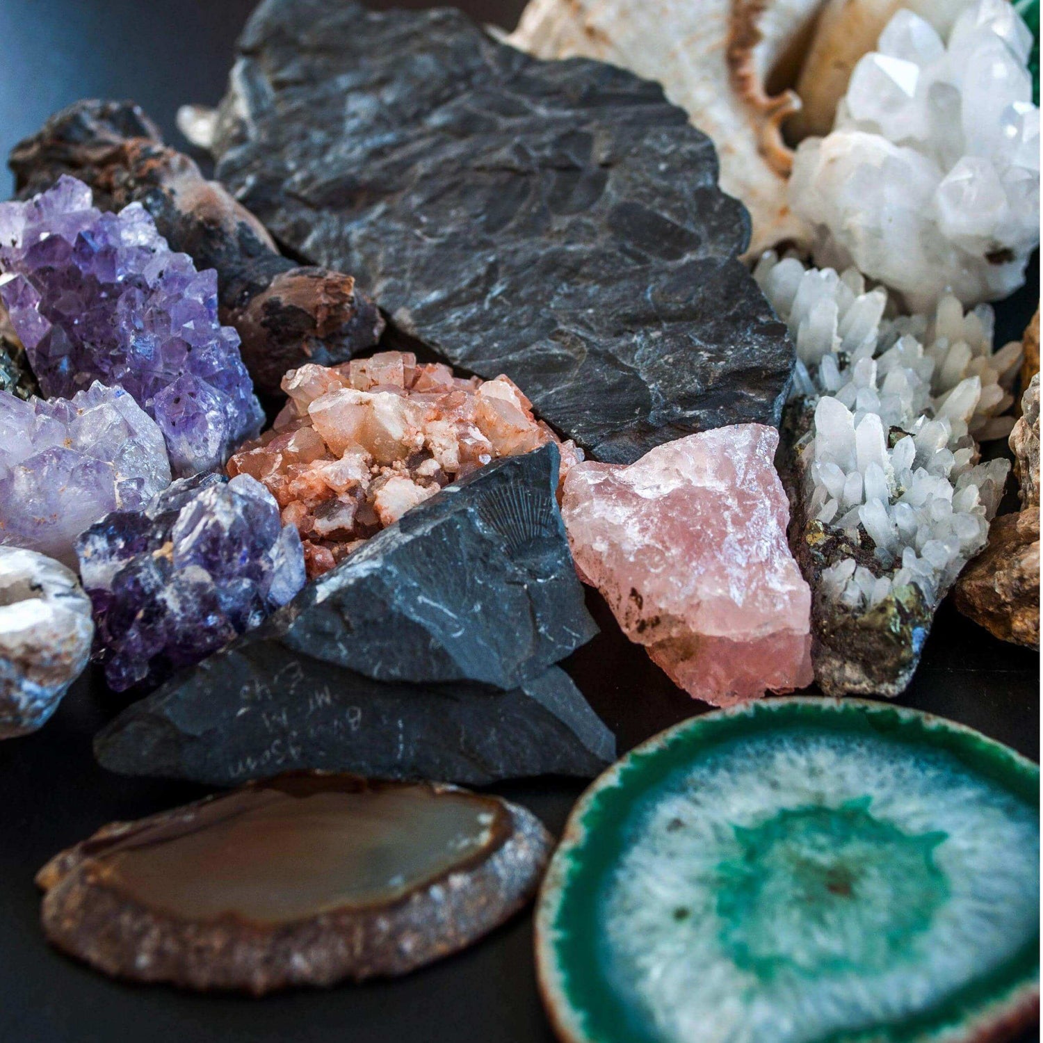 A variety of raw crystals, including amethyst, quartz, and agate, showcasing their natural beauty and vibrational energy.