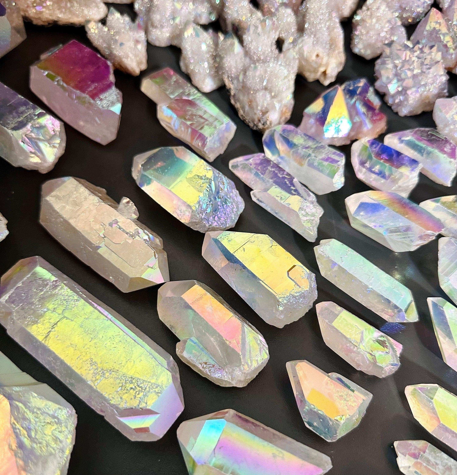 Colorful Aura Quartz crystals with metallic sheen, showcasing unique energy and beauty in various shapes.