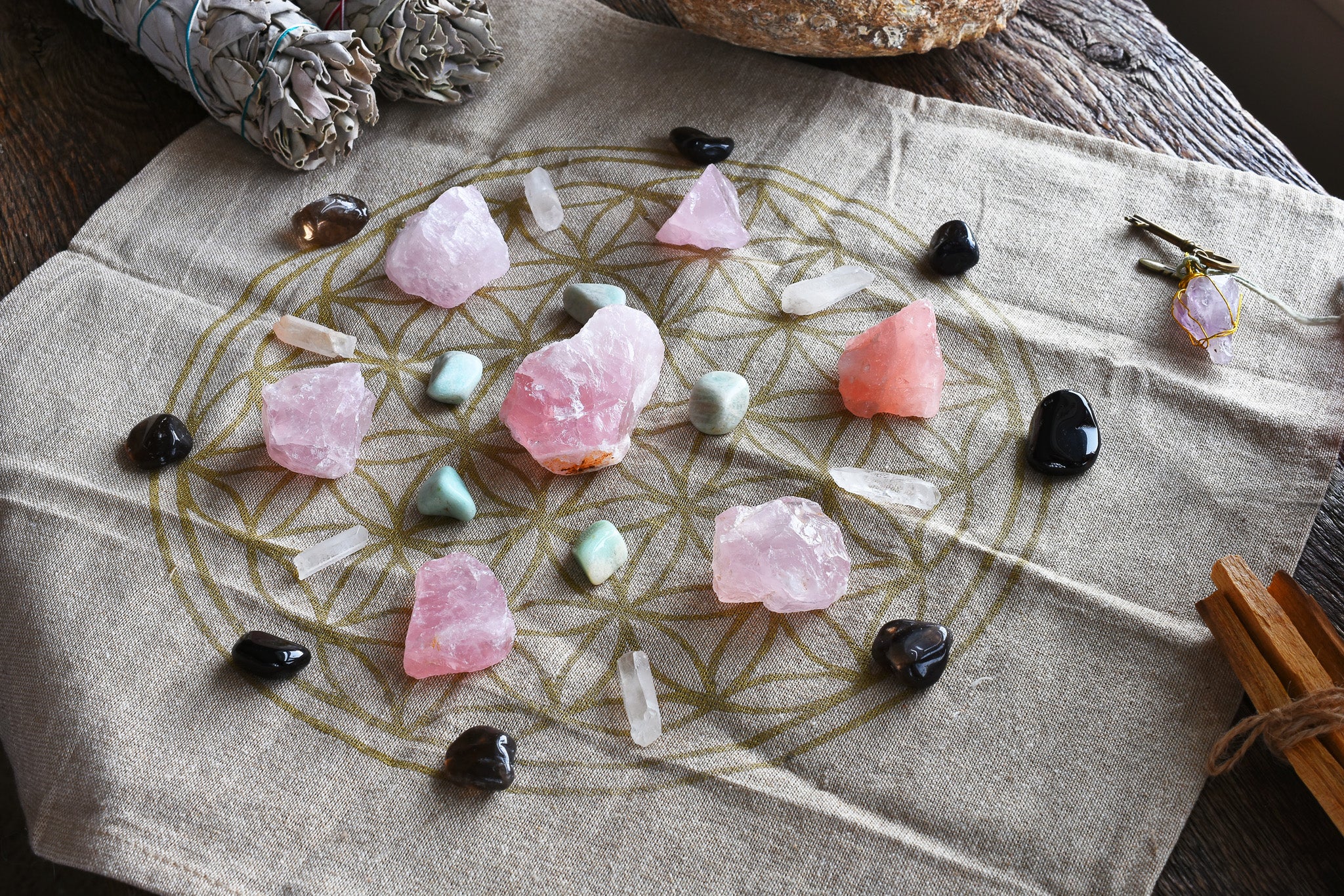 Arrangement of healing crystals including rose quartz on a floral-patterned fabric. Perfect for spiritual rituals.